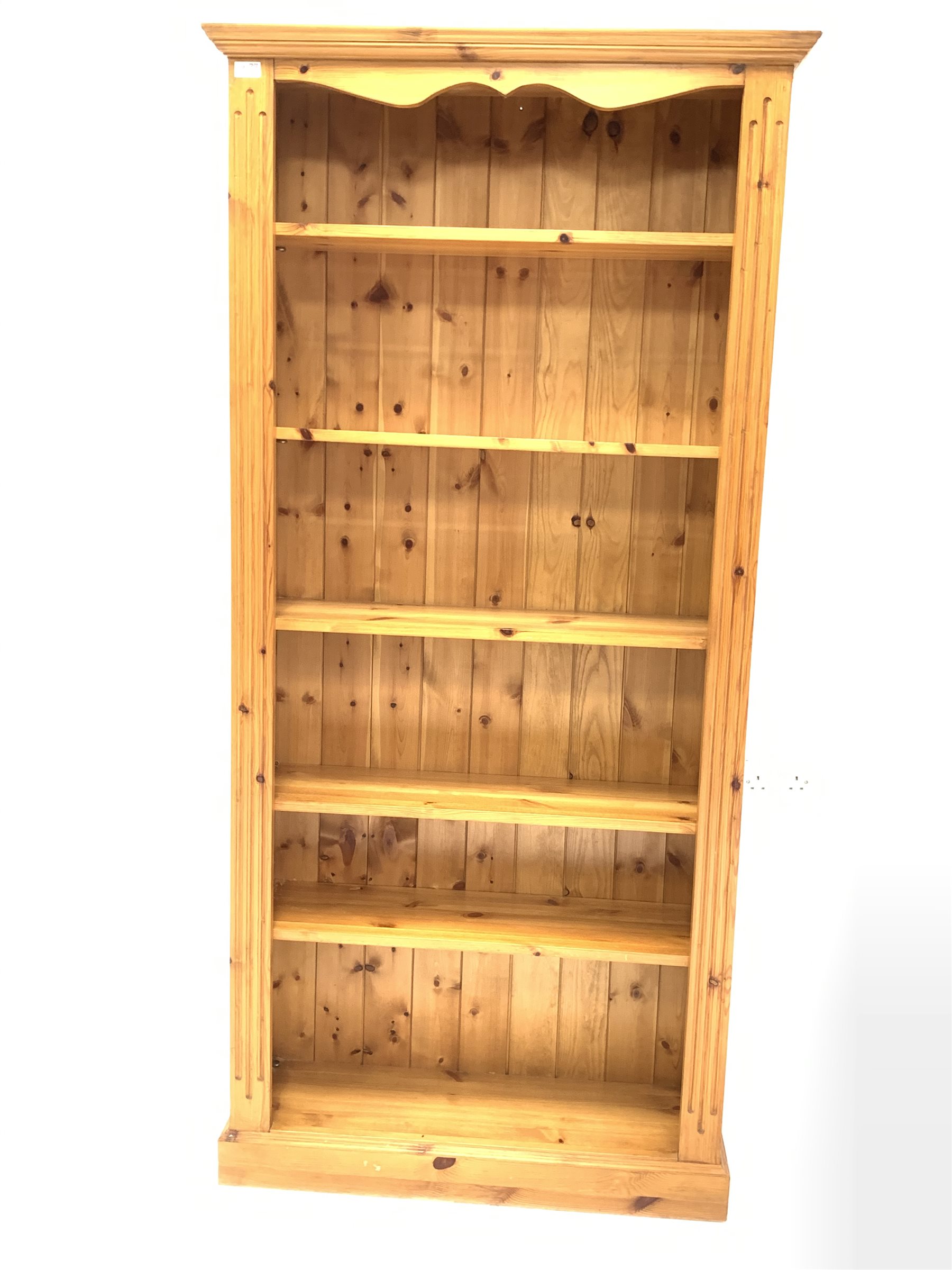 Solid pine open bookcase with fluted decoration enclosing five