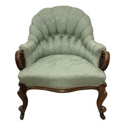 19th century mahogany framed fan-back armchair, upholstered in buttoned turquoise floral damask fabric with spring seat and pearlescent piping, pierced and carved arm terminals with floral motif, over serpentine fronted seat, raised on cartouche carved cabriole supports with castors