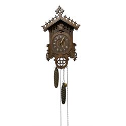 German -  late 19th century Black Forrest weight driven two train cuckoo clock, with carved decoration to the pediment and front of the case, hand carved bone hands and numerals and opening side doors, with a carved cuckoo and original pipes and bellows. With pine cone weights and pendulum.