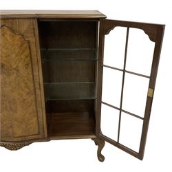 Early 20th century walnut breakfront display cabinet, central serpentine cupboard with figured facia and shaped moulding, flanked by two astragal glazed doors, on acanthus cabriole feet