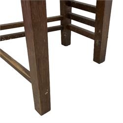 In the manner of Charles Rennie Mackintosh - contemporary pair of oak high ladder back hall chairs, on square supports united by stretchers 