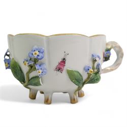 Pair of Meissen tea cups and saucers, encrusted with forget-me-nots and decorated with flowers and insects, raised on peg feet, H8cm and an early 20th century Meissen teapot, decorated with courting couples, H12cm (3)