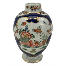 18th century Worcester tea caddy, of oval form and painted in the Kakiemon palette with reserves of flowers against a blue scale ground, H14cm together with a similar Worcester circular dish, painted with floral sprays, within a scalloped edge, blue crescent mark beneath, D19cm (2)