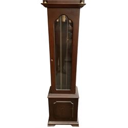 20th century - 8-day Mahogany longcase clock, with a swans necked pediment and break arch hood door beneath,  glazed door with visible brass cased weights and pendulum, on a rectangular plinth with a raised panel and bracket feet, brass dial with a silvered dial centre and chapter ring, chain driven three train movement chiming the quarters and hours on gong rods. With weights and pendulum.  