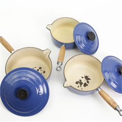 Set of three Le Creuset blue enamel saucepans, on a pierced blue painted cast iron stand, H68cm Le Creuset oval oven dish, casserole pot and other ovenwares 