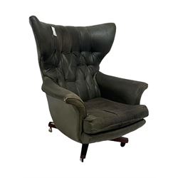 G-Plan - mid-20th century 'Blofeld' model 62 swivel wingback armchair, upholstered in green faux leather, on castors