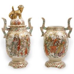 Pair of early 20th century Japanese Satsuma vases, of twin-handled form, one with temple lion finial cover, painted with immortals against a dense cloud and geometric patterned ground, H33cm