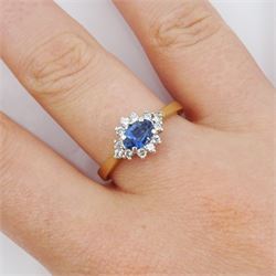 9ct gold oval sapphire and round brilliant cut diamond cluster ring, hallmarked London 1994, sapphire approx 0.55 carat, total diamond weight approx 0.25 carat