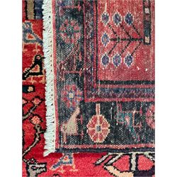 Persian crimson ground runner, the field decorated with stylised tree and animal motifs, indigo ground border decorated with alternating stylised flowerhead and bird motifs 