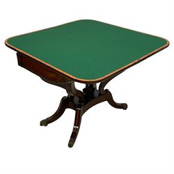 Regency inlaid rosewood card table, rectangular swivel and fold-over top with rounded corners and baize lined interior, the frieze decorated with a central ebony panel with applied gilt metal swan motifs, over a brass inlay band, raised on S-scroll supports united by concave platform base, terminating to out-splayed supports with brass cups and castors