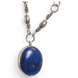 Early 20th century silver bell pendant, Birmingham 1915, on later silver chain, silver chain necklaces, silver garnet ring and a silver lapis lazuli pendant on white metal chain