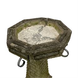 Circular cast stone garden planter decorated with flower head band (D44cm, H28cm); smaller planter (D34cm, H27cm); composite stone rusticated bird bath, octagonal top on tapering pedestal (W41cm, H65cm) (3)