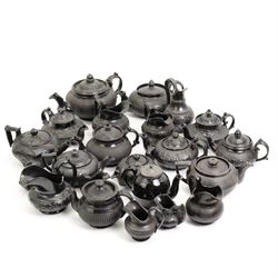 Early 19th century and later black basalt tea wares and similar stoneware, mostly with relief or engine turned bodies, including bachelors teapots, milk jugs, sucriers etc, in one box