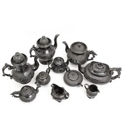 Early 19th century and later black basalt tea wares, mostly with relief or engine-turned bodies, including four large teapots, one with bird finial, bachelors teapots etc in one box