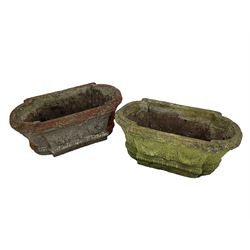 Pair of cast stone garden planters, rectangular form with stepped rounded ends, foliate moulded rim, the body decorated with floral and fruit festoons over gadrooned moulding