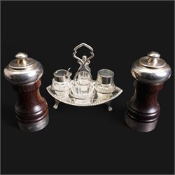 Edwardian small silver navette shape four division cruet fitted with glass and silver mounted bottles London 1902 Maker Hukin & Heath and a pair of mahogany silver banded pepper mills London 1980 Maker Davis Shaw Silverware 