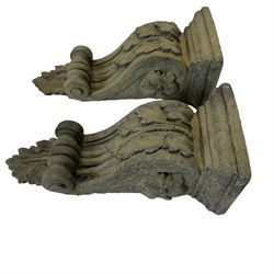 Pair of Victorian design cast stone architectural corbel wall brackets, stepped rectangular top over a scrolled bracket with relief acanthus leaf decoration and rosette motifs to the side