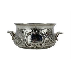 Victorian silver circular sugar bowl with embossed floral decoration and shaped handles, cartouches engraved with initials D11.5cm London 1859 Maker Edward Ker Reid