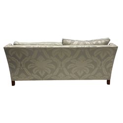 Duresta - Grande hardwood-framed three-seat sofa, upholstered in pale fabric decorated with repeating foliate pattern, on square tapering supports with brass castors 