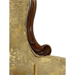 Victorian mahogany framed armchair, shaped and moulded frame carved with curled foliage, upholstered in pale gold floral pattern silk damask fabric, scrolled arm terminals on shaped moulded supports terminating to scroll carved feet