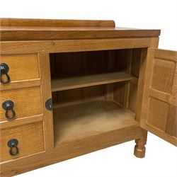 Mouseman - oak 6' sideboard, raised back over adzed top, fitted with three central drawers and flanking cupboards, enclosed by panelled doors, with wrought iron handles, latches and hinges, two fixed internal shelves, on octagonal feet, by the workshop of Robert Thompson, Kilburn 