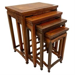 Early 20th century Chinese hardwood quarteto nest of tables, carved frieze over square moulded supports united by shaped stretchers