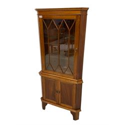 Georgian design mahogany floor standing corner display cabinet, astragal style glazed door enclosing two glass shelves, fitted with double panelled cupboard to base