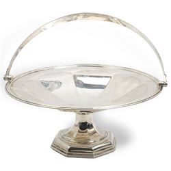 Silver circular fruit dish with swing handle of panelled design on a pedestal base and  octagonal foot D28cm Sheffield 1918 Maker Walker & Hall  