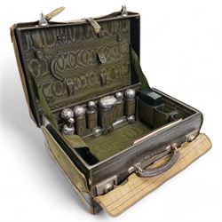 Edwardian ladies leather travelling dressing case by Army & Navy Co-operative Society, the watered silk interior with silver mounted glass bottles, leather jewellery box, leather folding stationery case and inkwell etc the silver hallmarked for London 1901 Maker Frederick Bradford Macrae 47cm x 33cm with outer canvas case