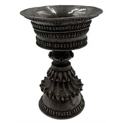 19th century Tibetan silver butter lamp, the bowl with everted rim, the stem with embossed lotus petals on a swept conical foot H10cm