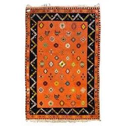 Moroccan amber ground thick pile rug, the field decorated with stylised geometric lozenges and roods, interspersed with camel motifs, the guard bands with stylised foliate and plant motifs