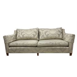 Duresta - Grande hardwood-framed three-seat sofa, upholstered in pale fabric decorated with repeating foliate pattern, on square tapering supports with brass castors 