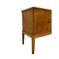 Gordon Russell - walnut sideboard, rectangular moulded top over three central drawers and flanking cupboards, fitted with turned handles, on tapering supports 