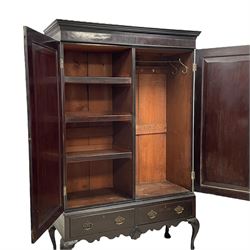 19th century Irish mahogany press wardrobe, projecting dentil cornice over two figured panelled doors, enclosing three sliding trays and hanging rail with coat hooks, fitted with two drawers to base over a shaped apron, raised on acanthus carved cabriole supports with paw feet, retailed by Millar & Beatty of Dublin, with paper labels verso, collected and restored by Michael Butler (1870-1900), impressed stamp to side and ink stamp to drawer inscribed 'M Butler collector of high-class furniture and works of art'