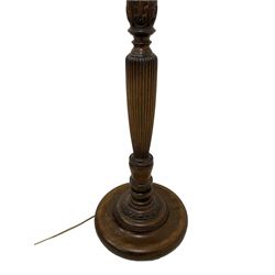 20th century Hepplewhite design stained beech standard lamp, turned and reeded column with trailing bellflower and foliage decoration, on turned circular base, with cream upholstered shade 