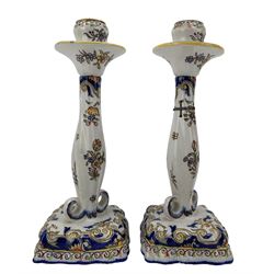 Pair of 19th century Fourmaintraux Freres Desvres faience candlesticks, each decorated with foliate scrolls, flowers, together with a similar later pair of candlesticks, H25.5cm (4)