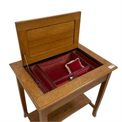 Early 20th century oak sewing or work table, moulded rectangular top with hinged compartment, fabric lined interior fitted with divisions, on square supports with out-splayed feet, untied by undertier 