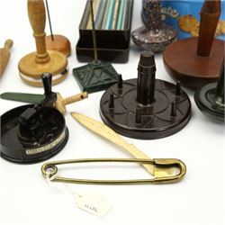 Sewing and Haberdashery Tools and Accessories to include a brass stitch pin, in the form of a paperclip, stamped Anchor, various darning mushrooms, buttons, Dewhurst's ceramic needle box, knitting needles, miniature wooden model of a spinning wheel, wool winder, bakelite wool cutter etc 