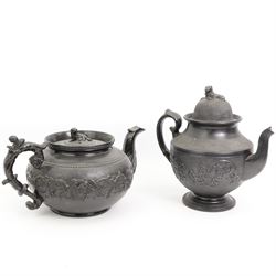 Early 19th century and later black basalt tea wares, mostly with relief or engine-turned bodies, including a large Cyples teapot with dog finial and scroll handle, a similar coffee pot with lion finial, bachelors teapots etc and three related books in one box