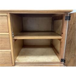 Gordon Russell - walnut sideboard, rectangular moulded top over three central drawers and flanking cupboards, fitted with turned handles, on tapering supports 