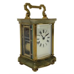 French - early 20th century two train carriage clock, in an onyx serpentine case raised on bun feet, with four bevelled panels and rectangular escapement viewing panel, white enamel dial with Roman numerals and steel spade hands, 8-day movement with a jewelled lever platform escapement and rack striking, sounding the hours and half hours on a coiled gong. With key.