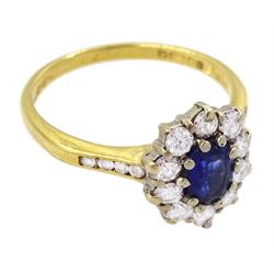 18ct gold oval cut sapphire and round brilliant cut diamond cluster ring, with diamond set shoulders, London 1990, total diamond weight approx 0.60 carat