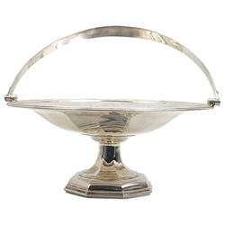 Silver circular fruit dish with swing handle of panelled design on a pedestal base and  octagonal foot D28cm Sheffield 1918 Maker Walker & Hall  