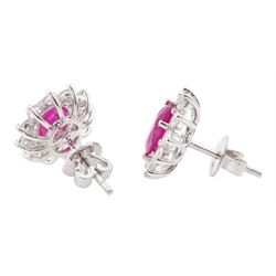 Pair of 18ct white gold oval cut ruby and round brilliant cut diamond cluster stud earrings, stamped 750, total ruby weight approx 2.70 carat, total diamond weight approx 0.80 carat