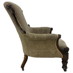 William IV mahogany framed armchair, rolled back with scroll carved uprights, acanthus carved arm terminals over serpentine fronted seat, raised on turned and lobe carved supports with castors