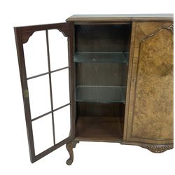 Early 20th century walnut breakfront display cabinet, central serpentine cupboard with figured facia and shaped moulding, flanked by two astragal glazed doors, on acanthus cabriole feet