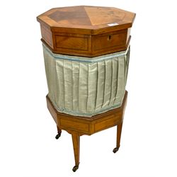 19th century satinwood sewing or work table, octagonal form enclosed by hinged lid, the interior with removal section with lidded compartments concealing storage well, upholstered in pleated silk, inlaid with ebony stringing, on square tapering supports with brass castors 
