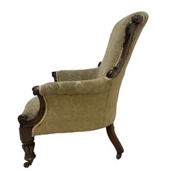 William IV mahogany framed armchair, rolled back with scroll carved uprights, acanthus carved arm terminals over serpentine fronted seat, raised on turned and lobe carved supports with castors