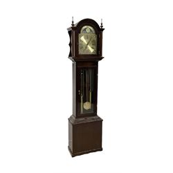 20th century - Westminster chime 8-day grandmother clock in a mahogany case, with a break arch top and brass finials, fully glazed trunk door with visible brass cased weights and pendulum, brass dial with etched dial centre and spandrels, chapter ring with Roman numerals and working moon disc to the arch, two train chain driven movement with 12 gong rods and chime selection for the quarters and hours.