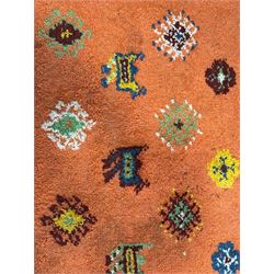 Moroccan amber ground thick pile rug, the field decorated with stylised geometric lozenges and camel motifs, the guard bands with stylised foliate and plant motifs